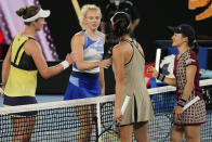 Czech Republic's Barbora Krejcikova, left, and Katerina Siniakova, second right, are congratulated by Japan's Shuko Aoyama, right, and Ena Shibahara following the women's doubles final at the Australian Open tennis championship in Melbourne, Australia, Sunday, Jan. 29, 2023. (AP Photo/Aaron Favila)