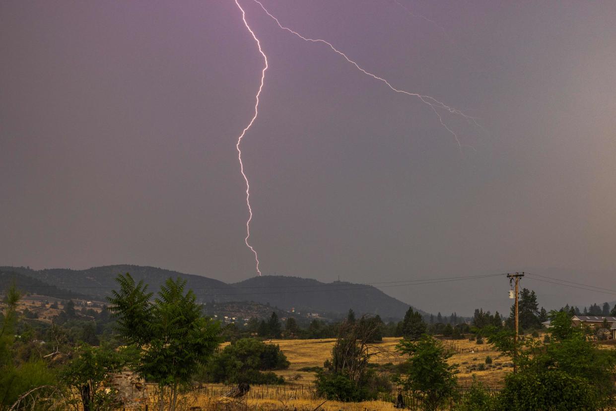 Lightning strikes east of the eastern front of the McKinney Fire, in the Klamath National Forest near Yreka, Calif. on Aug, 2, 2022.