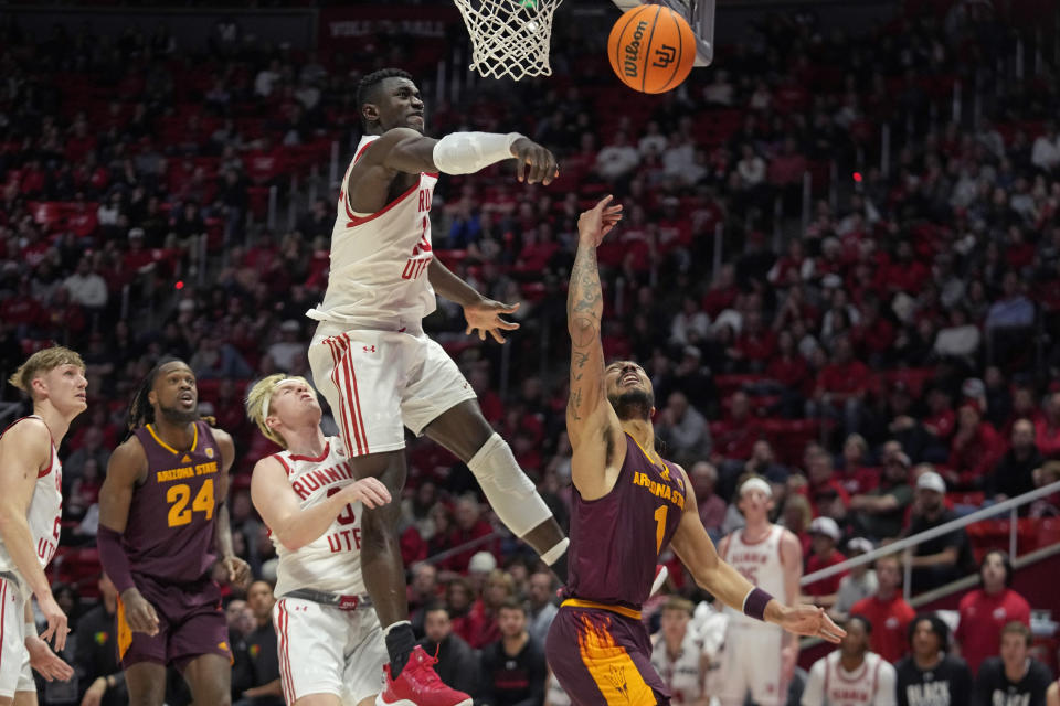 Utah center Keba Keita (13) blocks the shoot from Arizona State guard Frankie Collins (1) during the first half of an NCAA college basketball game Saturday, Feb. 10, 2024, in Salt Lake City. (AP Photo/Rick Bowmer)