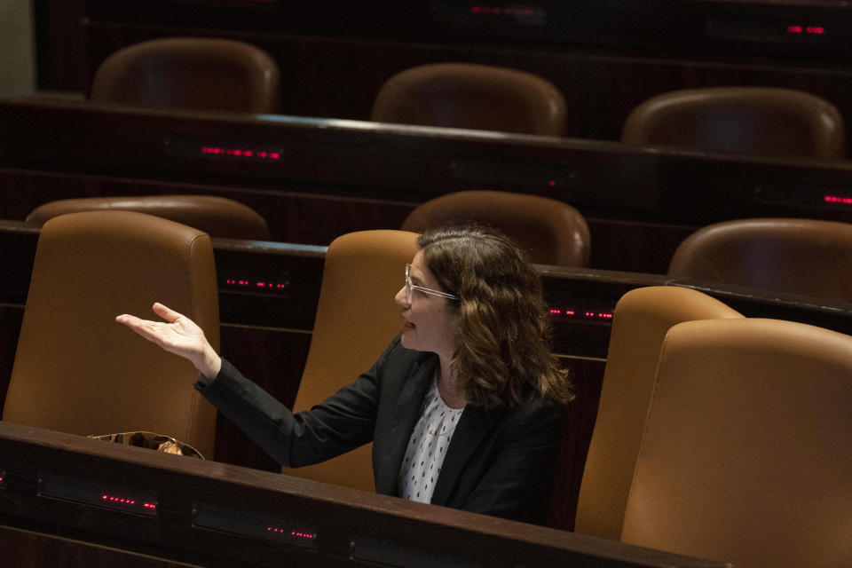 Israeli Environment Minister Tamar Zandberg replies to a speaker during the opening of the summer session of the Knesset, Israel's parliament, in Jerusalem, Monday, May 9, 2022. Less than a year after taking office, Prime Minister Naftali Bennett has lost his parliamentary majority, his own party is crumbling and a key governing partner has suspended cooperation with the coalition. That has set the stage for a possible attempt by the opposition, led by former Prime Minister Benjamin Netanyahu, to topple the government later this week. (AP Photo/Maya Alleruzzo)