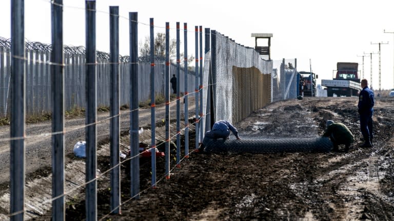 Prisoners build a new, second fence at the Hungarian-Serbian border near Gara village in October 2016