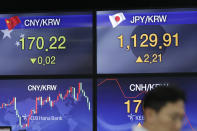 A currency trader walks near screens showing the foreign exchange rates at the foreign exchange dealing room in Seoul, South Korea, Thursday, Aug. 22, 2019. Asian stock markets are mixed Thursday following Wall Street’s rebound as investors looked ahead to a speech by the U.S. Federal Reserve chairman for clues about possible interest rate cuts. (AP Photo/Lee Jin-man)