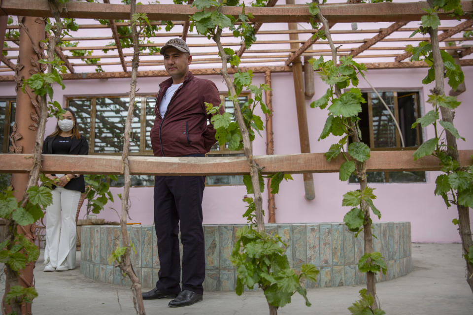 Mamatjan Ahat, a truck driver, stands in the courtyard of his home in Aksu in far west China's Xinjiang region, after telling journalists he recanted religion during a government organized visit for foreign journalists on April 19, 2021. Four years after Beijing's brutal crackdown on largely Muslim minorities native to Xinjiang, Chinese authorities are dialing back the region's high-tech police state and stepping up tourism. But even as a sense of normality returns, fear remains, hidden but pervasive. (AP Photo/Mark Schiefelbein)