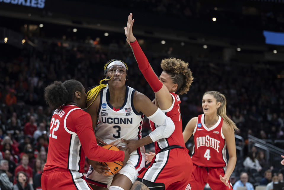 UConn forward Aaliyah Edwards (3) attempts to drive past Ohio State forward Eboni Walker (22) and guard Rikki Harris during the first half of a Sweet 16 college basketball game of the NCAA tournament, Saturday, March 25, 2023, in Seattle. (AP Photo/Stephen Brashear)