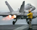 A US Navy F-/A-18C Hornet takes off from the USS Kitty Hawk in northern Gulf waters on March 25, 2003