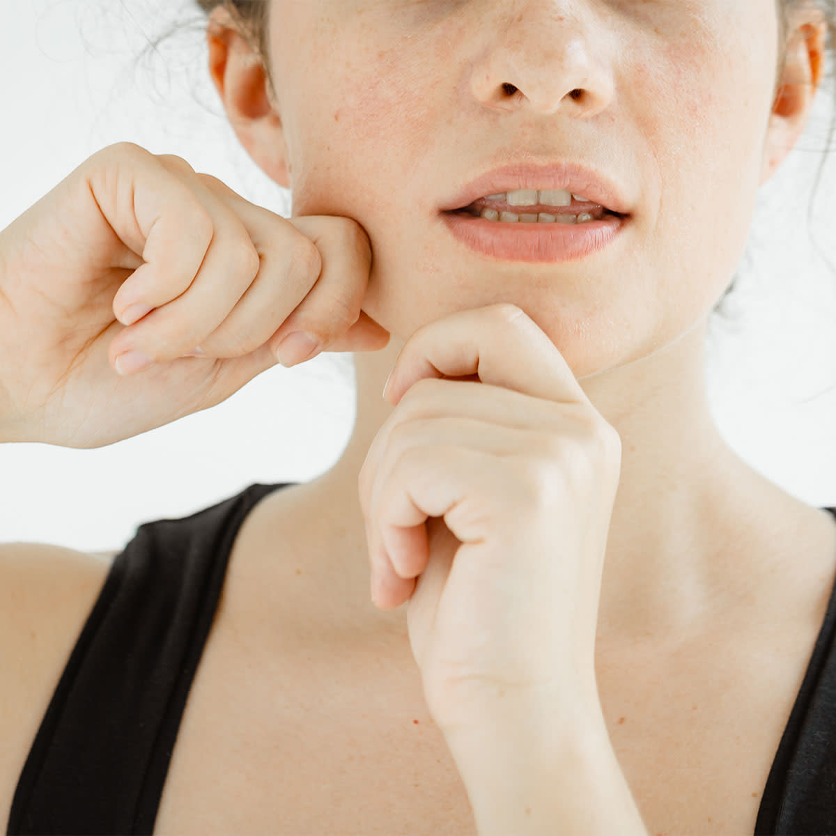 woman-performing-facial-massage-to-jawline