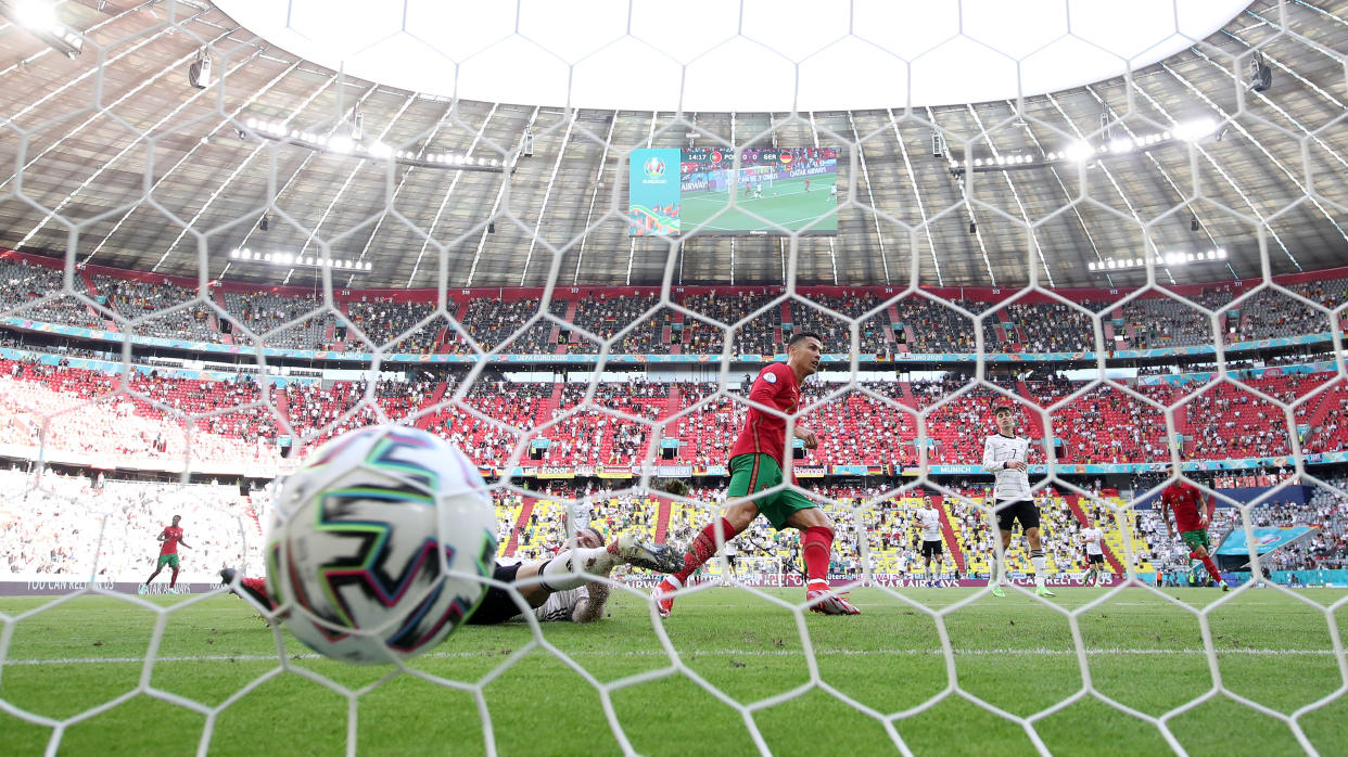 MUNICH, GERMANY - JUNE 19: Cristiano Ronaldo of Portugal scores their side's first goal during the UEFA Euro 2020 Championship Group F match between Portugal and Germany at Football Arena Munich on June 19, 2021 in Munich, Germany. (Photo by Alexander Hassenstein/Getty Images)