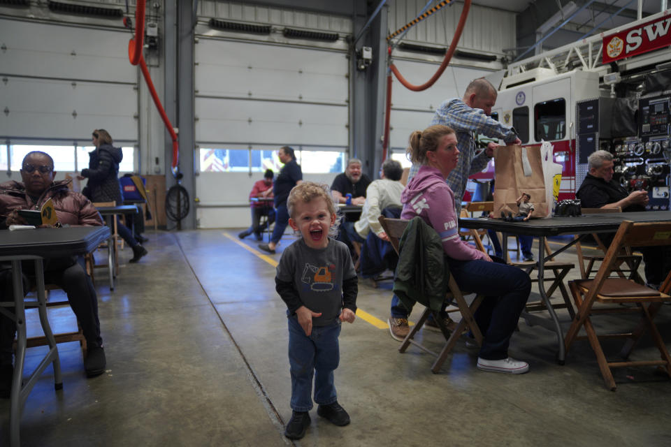Patrick Spade, 2, plays while waiting for his food at the Swissvale Fire Department's annual fish fry in Pittsburgh, on Friday, Feb. 24, 2023. (AP Photo/Jessie Wardarski)