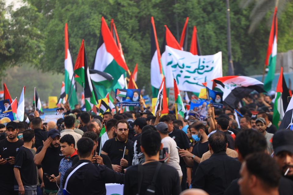 Protesters march and fly the Palestinian flag in Baghdad, Iraq.