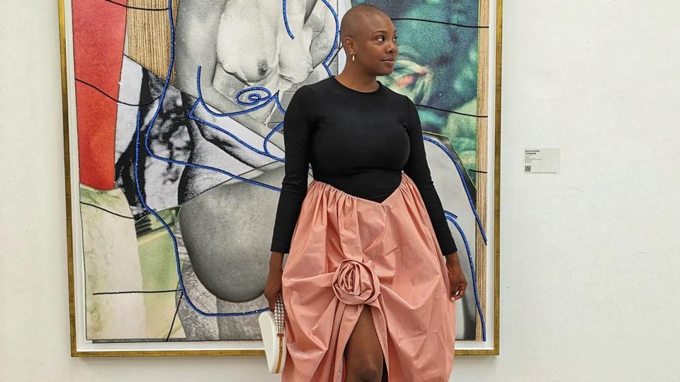 Yomi Adegoke attends a gallery opening in a black and pink dress