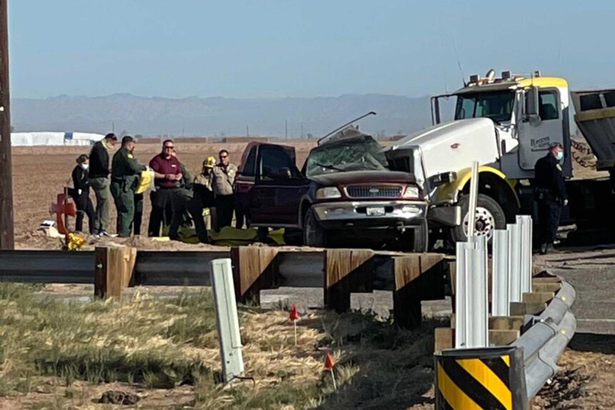 In this image from KYMA law enforcement work at the scene of a deadly crash involving a semi-truck and an SUV in Holtville, Calif. on Tuesday, March 2, 2021.