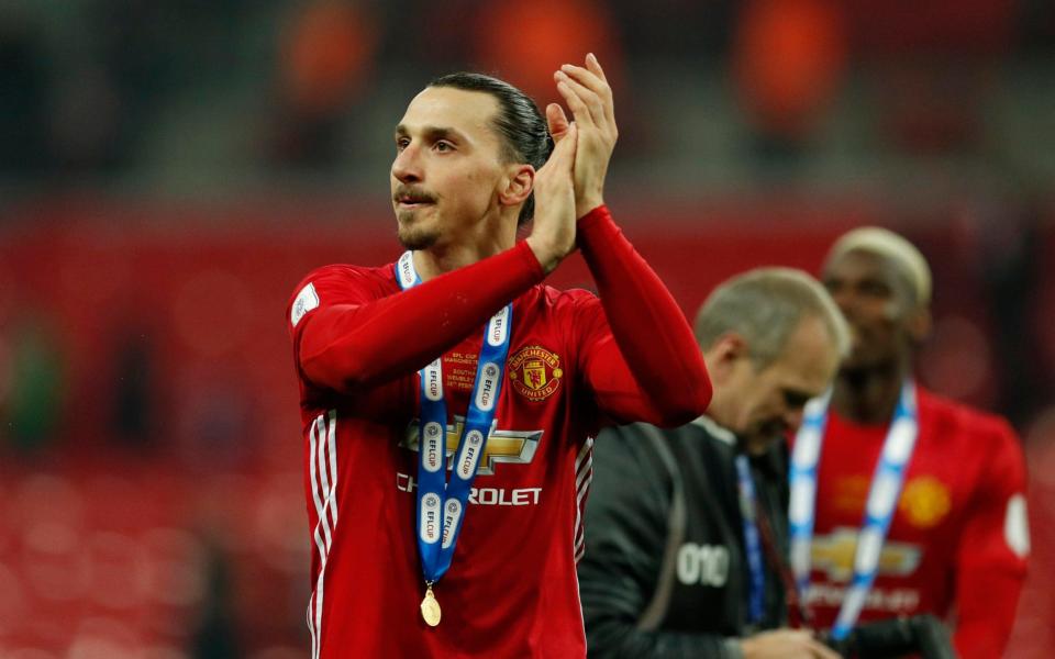 Manchester United's Zlatan Ibrahimovic applauds fans as he celebrates winning the EFL Cup Final  - Credit:  Reuters