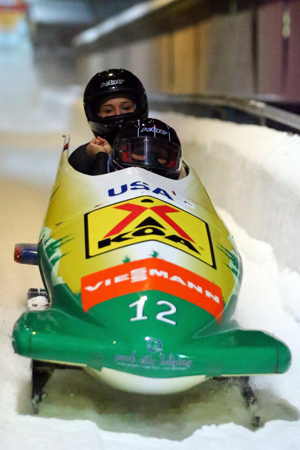 WINTERBERG, GERMANY - DECEMBER 08: Olympic champion Lolo Jones (L) and Elana Meyers of United States speed during the team competition of the FIBT Bob & Skeleton World Cup at Bobbahn Winterberg on December 8, 2012 in Winterberg, Germany. (Photo by Christof Koepsel/Bongarts/Getty Images)