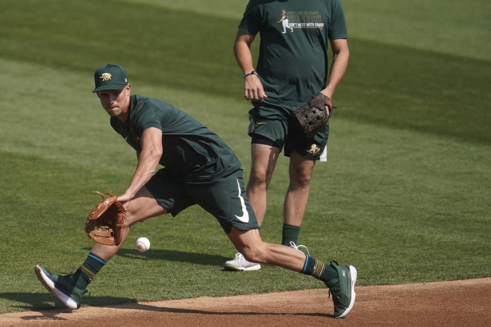 Oakland Athletics third baseman Jake Lamb fields a ground ball during a baseball workout in Oakland, Calif., Monday, Sept. 28, 2020. The Athletics are scheduled to play the Chicago White Sox in an American League wild-card playoff series starting Tuesday. (AP Photo/Jeff Chiu)