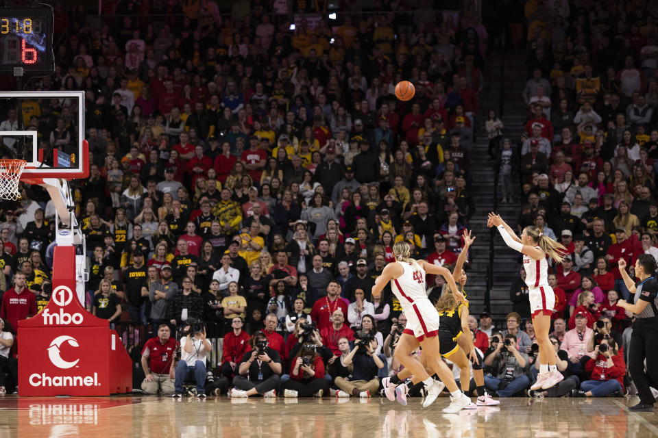 Nebraska's Jaz Shelley, second from right, shoots a 3-point basket against Iowa to take the lead with seconds remaining in an NCAA college basketball game Sunday, Feb. 11, 2024, in Lincoln, Neb. (AP Photo/Rebecca S. Gratz)