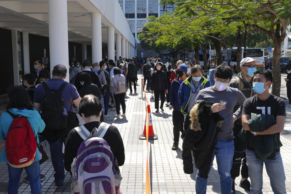 Residents queue up to get tested for the coronavirus at a temporary testing center for COVID-19 in Hong Kong, Monday, Feb. 14, 2022. Hong Kong residents expressed growing frustration last week after new, tighter coronavirus restrictions went into effect, imposed by city leaders in line with Beijing's zero-COVID policy. (AP Photo/Vincent Yu)