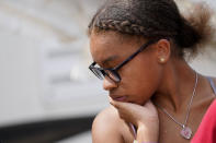 Amiah Winbush, 17, reacts as she looks at the damage to her family's auto detailing business in Lake Charles, La., in the aftermath of Hurricane Laura, Sunday, Aug. 30, 2020. (AP Photo/Gerald Herbert)