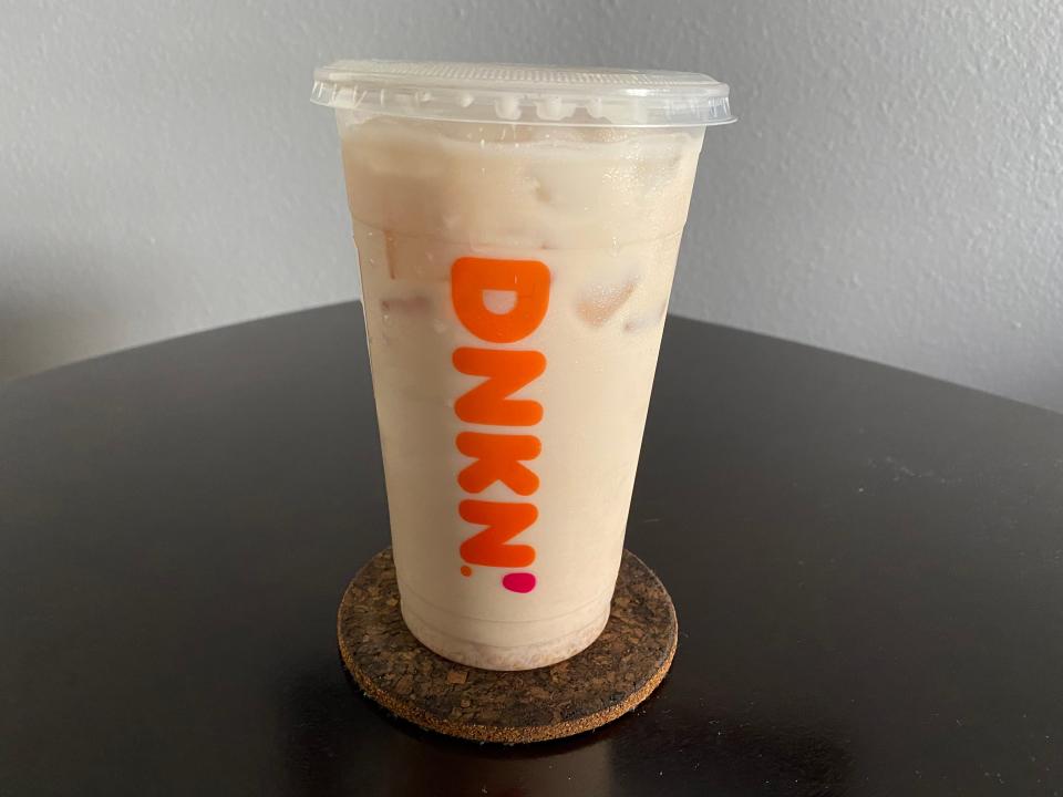 Dunkin' iced chai latte on a coaster