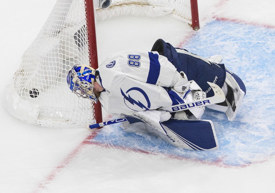 Tampa Bay Lightning goalie Andrei Vasilevskiy (88) looks back at the puck as it goes in past him for a goal by the New York Islanders during the second period of Game 3 of the NHL hockey Eastern Conference final, Friday, Sept. 11, 2020, in Edmonton, Alberta. (Jason Franson/The Canadian Press via AP)