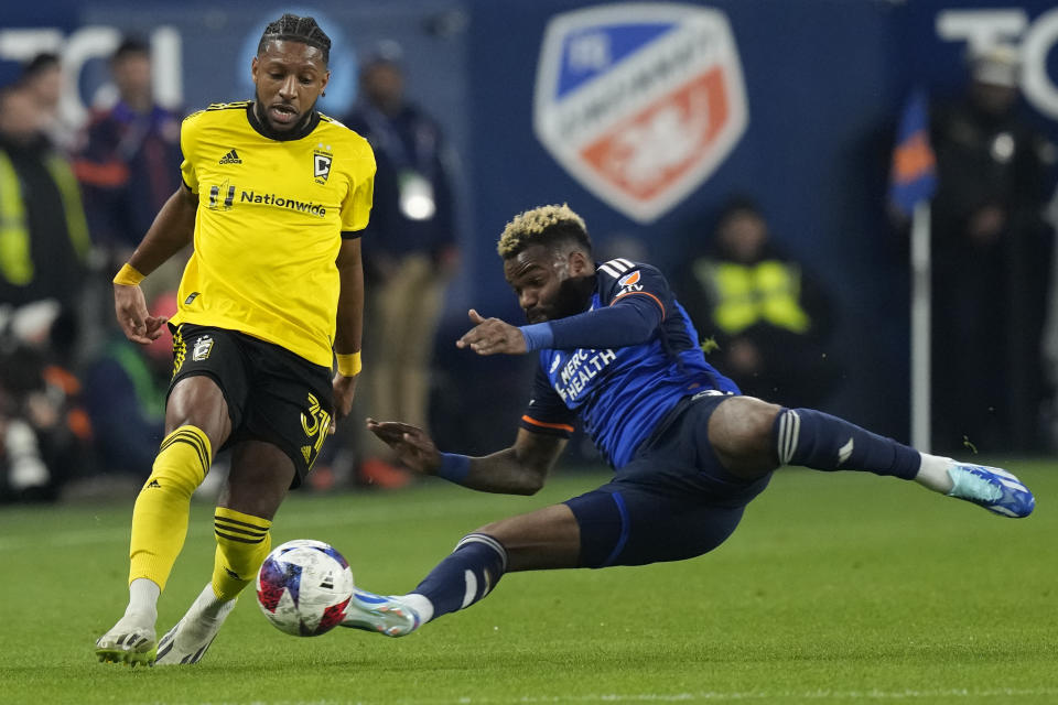 Columbus Crew defender Steven Moreira (31) and FC Cincinnati forward Aaron Boupendza (9) fight for the ball during the first half of an MLS Eastern Conference final soccer match, Saturday, Dec. 2, 2023, in Cincinnati. (AP Photo/Carolyn Kaster)