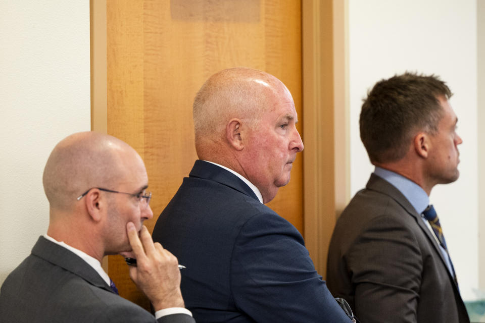 Defense attorneys Jared Ausserer, left, Brett Purtzer, center, and Casey Arbenz watch as witness Keyon Lowery draws out the intersection where the killing took place during the trial of Tacoma Police Officers Christopher Burbank, Matthew Collins and Timothy Rankine in the killing of Manny Ellis at Pierce County Superior Court, Tuesday, Oct. 10, 2023, in Tacoma, Wash. (Brian Hayes/The News Tribune via AP, Pool)