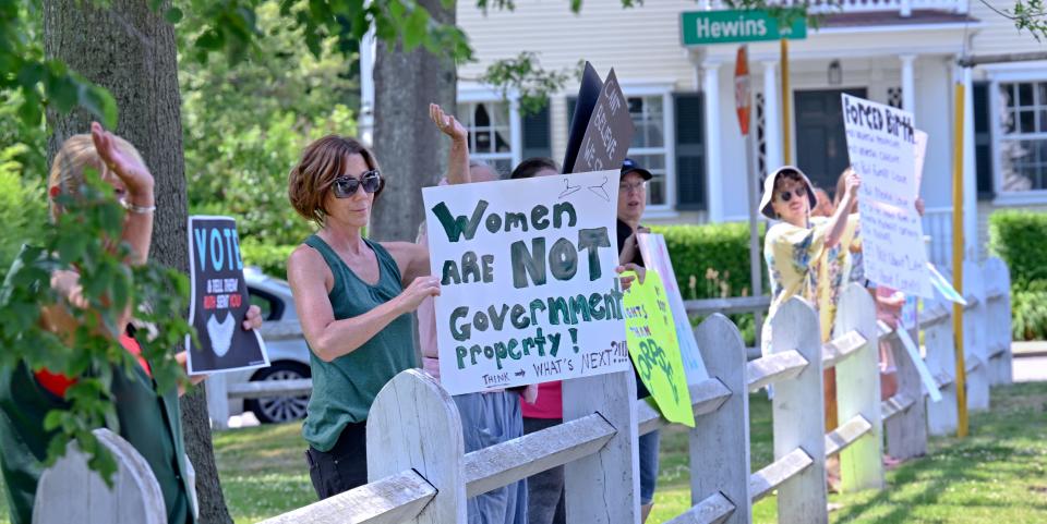 Participants wave to cars passing the village green holding signs objecting to the overturn of Roe v Wade. for gallery: https://www.capecodtimes.com/news/photo-galleries/