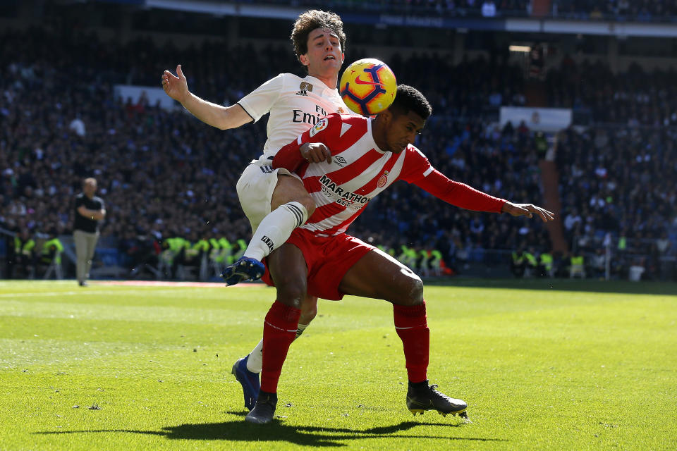 Real Madrid's Alvaro Odriozola, left, and Girona's Anthony Lozano battle for the ball during a La Liga soccer match between Real Madrid and Girona at the Bernabeu stadium in Madrid, Spain, Sunday, Feb. 17, 2019. (AP Photo/Andrea Comas)