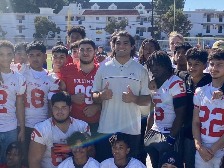 Rams rookie receiver Puka Nacua gives the thumbs among the football team when he visited Hollywood High earlier this season.