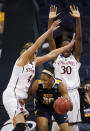 West Virginia center Asya Bussie (20) is trapped by Stanford's Joslyn Tinkle (44) and Nnemkadi Ogwumike (30) during the second half of an NCAA women's college basketball tournament second-round game in Norfolk, Va., Monday, March 19, 2012. Stanford won 72-55. (AP Photo/Steve Helber)