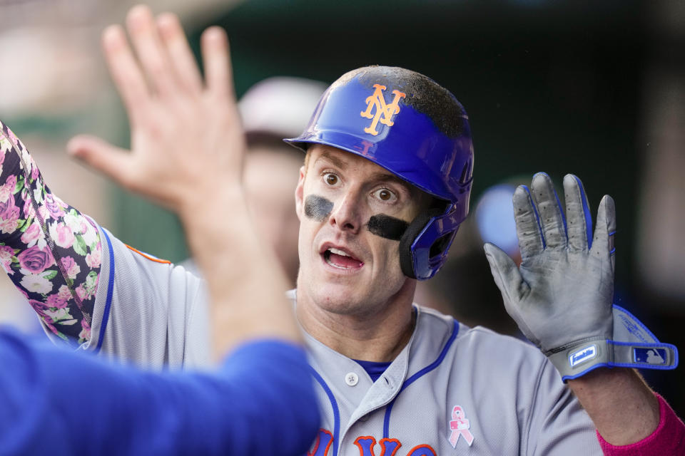 New York Mets' Mark Canha celebrates scoring during the fifth inning of a baseball game against the Washington Nationals at Nationals Park, Sunday, May 14, 2023, in Washington. (AP Photo/Alex Brandon)