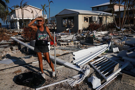 A woman surveys the damage to her mother's house following Hurricane Irma in Big Pine Key, Florida, U.S., September 18, 2017. REUTERS/Carlo Allegri