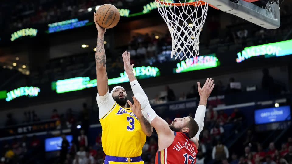 Anthony Davis heads to the hoop against Pelicans center Jonas Valanciunas. - Gerald Herbert/AP