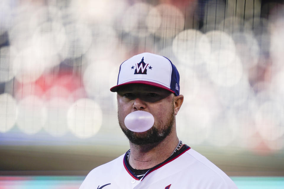 Washington Nationals starting pitcher Jon Lester blows a bubble as he walks to the dugout before the team's baseball game against the Philadelphia Phillies at Nationals Park, Wednesday, May 12, 2021, in Washington. (AP Photo/Alex Brandon)