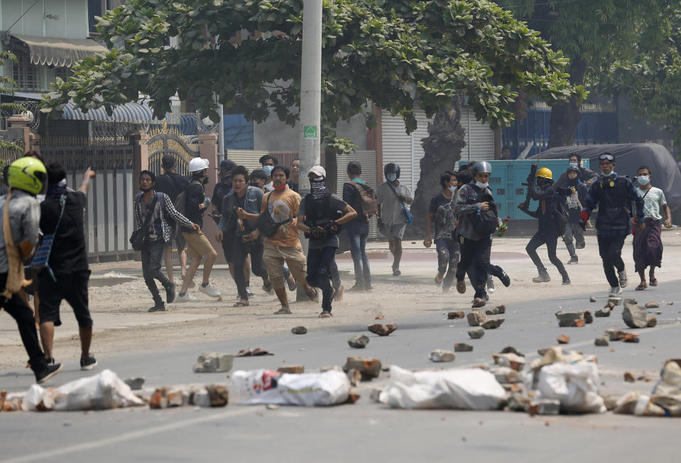 Demonstrators scatter as police fire tear gas during a protest against the military coup Saturday, March 27, 2021, in Mandalay, Myanmar. Myanmar security forces reportedly killed 93 people Saturday in the deadliest day since last month’s military coup. (AP Photo)