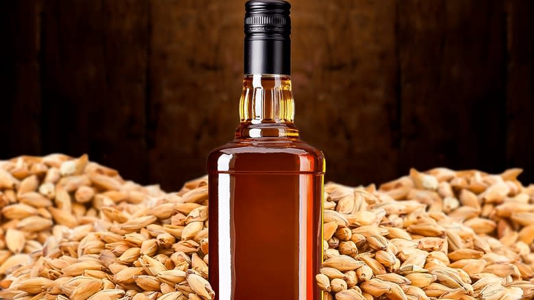 whiskey bottle surrounded by grains