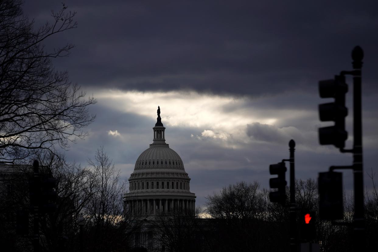 <p>Clouds pass over the U.S. Capitol on 17 January 2021 in Washington, DC. After last week's riots at the U.S. Capitol Building, the FBI has warned of additional threats in the nation's capital and in all 50 states.</p> (Getty Images)