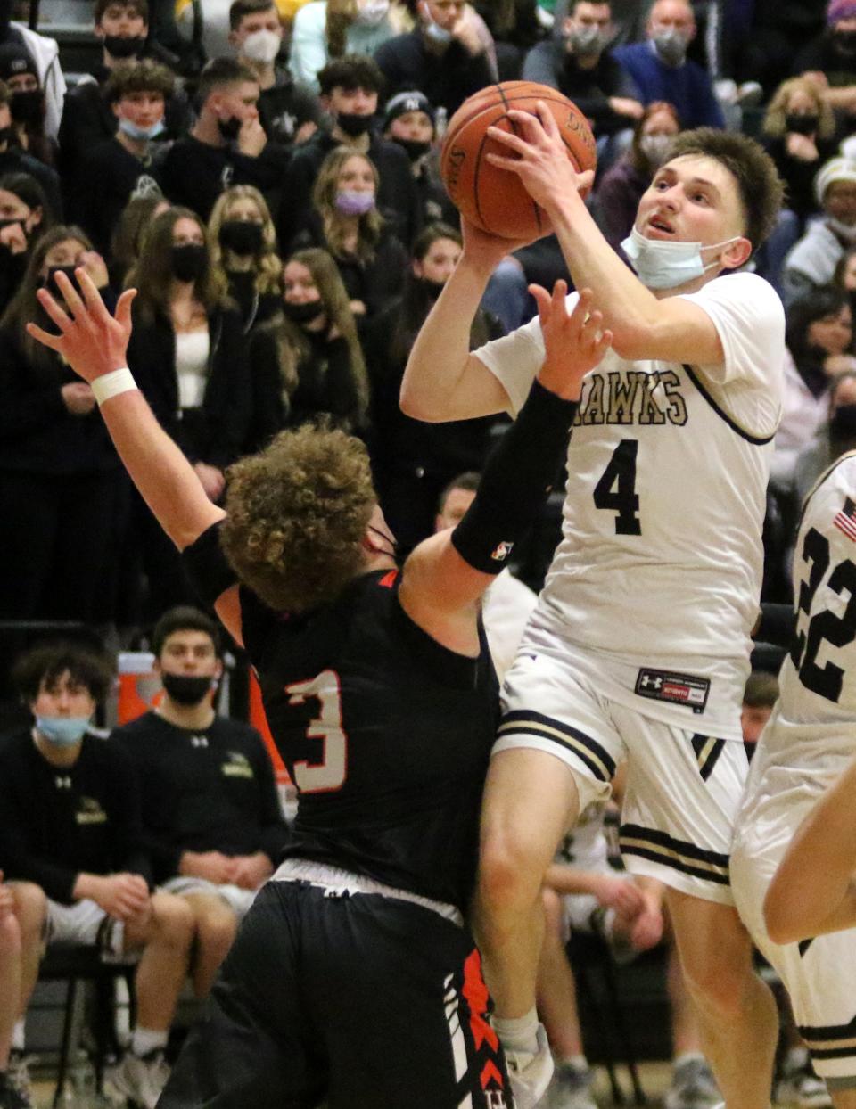 Corning's Jackson Casey takes a shot as Union-Endicott's Rocco Spinelli defends during U-E's 67-66, double-overtime win in the STAC boys basketball final Feb. 18, 2022 at Elmira High School.