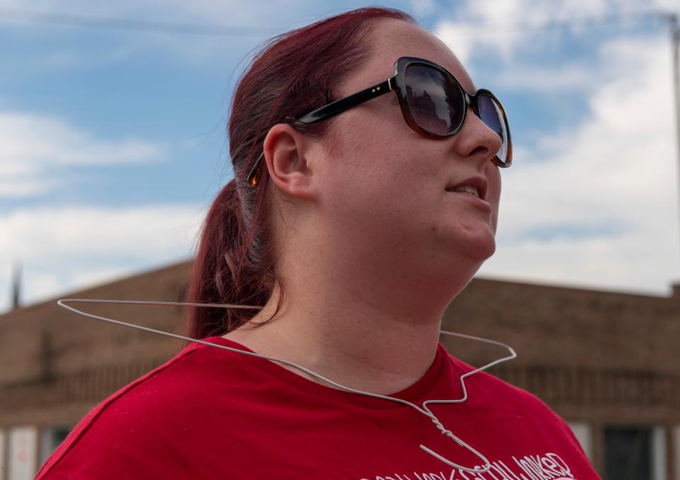 Macy Gentry of Evansville wears a hanger around her neck as she chants during an abortion rights rally in Downtown Evansville, Ind., Friday, June 24, 2022. The 6-3 decision by the U.S. Supreme Court upended the nearly five-decades-old case that had protected access to abortion under federal law.