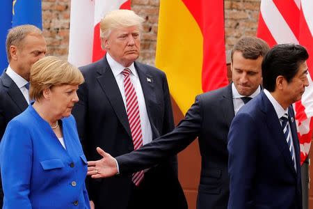 FILE PHOTO: From L-R, European Council President Donald Tusk, German Chancellor Angela Merkel, U.S. President Donald Trump, French President Emmanuel Macron and Japanese Prime Minister Shinzo Abe walk after a family photo during the G7 Summit in Taormina, Sicily, Italy, May 26, 2017. REUTERS/Jonathan Ernst/File Photo