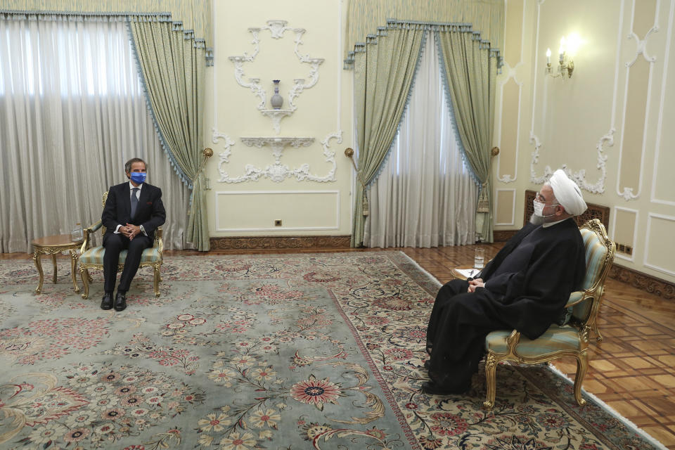 In this photo released by the official website of the office of the Iranian Presidency, President Hassan Rouhani, right, meets Director General of International Atomic Energy Agency, IAEA, Rafael Mariano Grossi at the presidency office in Tehran, Iran, Wednesday, Aug. 26, 2020. The U.N. nuclear watchdog agency said Wednesday that Tehran has agreed to allow inspectors in to two sites where Iran is suspected of having stored or used undeclared nuclear material. (Iranian Presidency Office via AP)