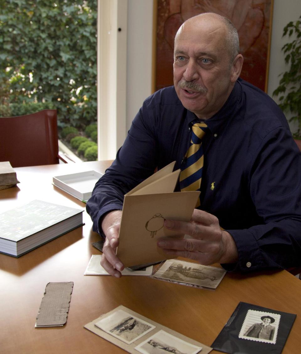 Author Patrick Lernout shows historic photos of American World War One soldiers, in his house in Waregem, Belgium on Monday, March 24, 2014. Lernout has spent 12 years writing a complete history of every single American soldier in the Flanders Field American Cemetery in Waregem. On Wednesday, March 26, 2014 President Barack Obama will honor those Americans who died in a struggle so all-encompassing, so horrific, it simply became known as the Great War. (AP Photo/Virginia Mayo)