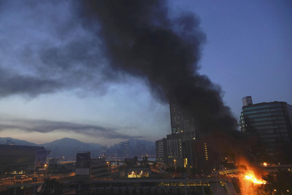 A fire burns near the campus of Hong Kong Polytechnic University in Hong Kong, early Monday, Nov. 18, 2019. Police stormed into a Hong Kong university campus held by protesters early Monday after an all-night siege that included firing repeated barrages of tear gas and water cannons. (AP Photo/Vincent Yu)