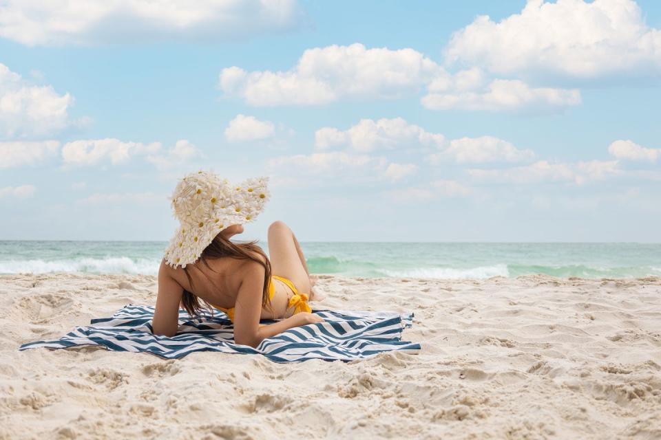 close up of woman on beach against sky