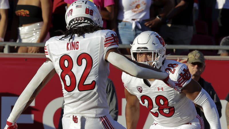 Utah Utes safety Sione Vaki (28) and tight end Landen King (82) celebrate Vaki’s touchdown against USC at the Los Angeles Memorial Coliseum on Saturday, Oct. 21, 2023.