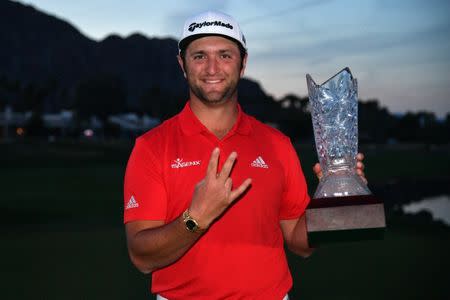 Jan 21, 2018; La Quinta, CA, USA; Jon Rahm gives the forks up gesture for his alma mater Arizona State University while holding the trophy after the final round of the CareerBuilder Challenge golf tournament at PGA West TPC Stadium Course. Mandatory Credit: Joe Camporeale-USA TODAY Sports