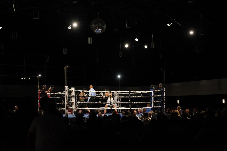 Boxers fight during a Detroit Brawl boxing event, Saturday, March 5, 2022, in Dearborn, Mich. Promoters Carlos Llinas and Salita are pushing the sport in the Detroit area with a periodic series of bouts in smaller venues in hopes of bringing it back to the masses. (AP Photo/Carlos Osorio)