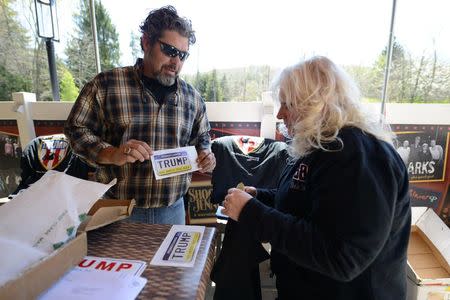 Organizer Chris Cox (L) offers merchandise to Pam Holman of Sewickley, Pennsylvania during a Bikers for Trump 2016 rally at Jergel's Rhythm Grille in Warrendale, Pennsylvania April 24, 2016. REUTERS/Alan Freed