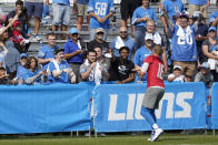 Detroit Lions quarterback Jared Goff (16) throws a football to fans after an NFL football training camp practice in Allen Park, Mich., Saturday, July 31, 2021. (AP Photo/Paul Sancya)