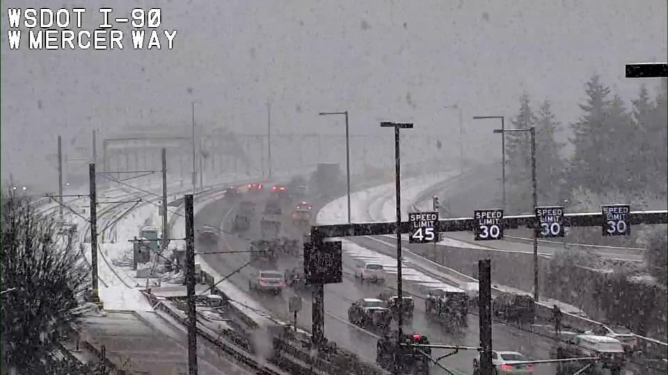Washington State Department of Transportation cameras showed snow falling around Western Washington Wednesday.
