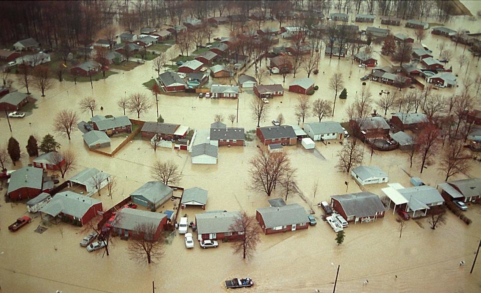 Water invaded homes in many South End neighborhoods, including these near Outer Loop, west of I-65, March 1, 1997. A long-range plan to help the hardest-hit residents relocate was being discussed.